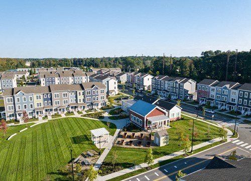 A large grassy area in front of apartment buildings.